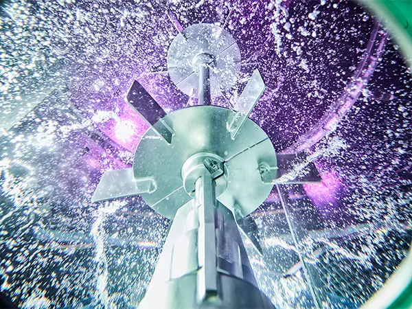 Large rushton impeller in motion in large glass reactor